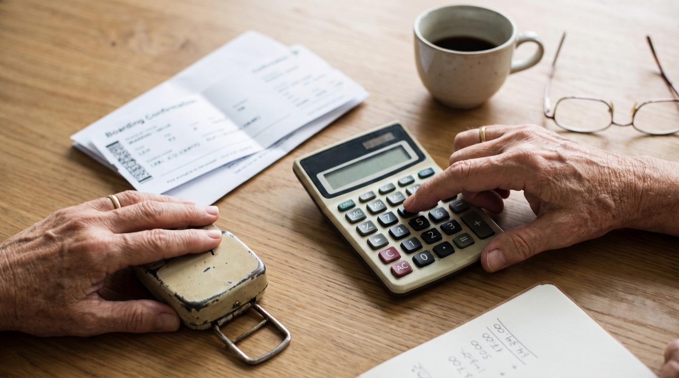 Traveler calculates total flight cost including bag and seat fees